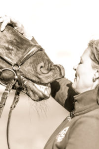young woman stroking head of a horse young woman stroking head of a horse